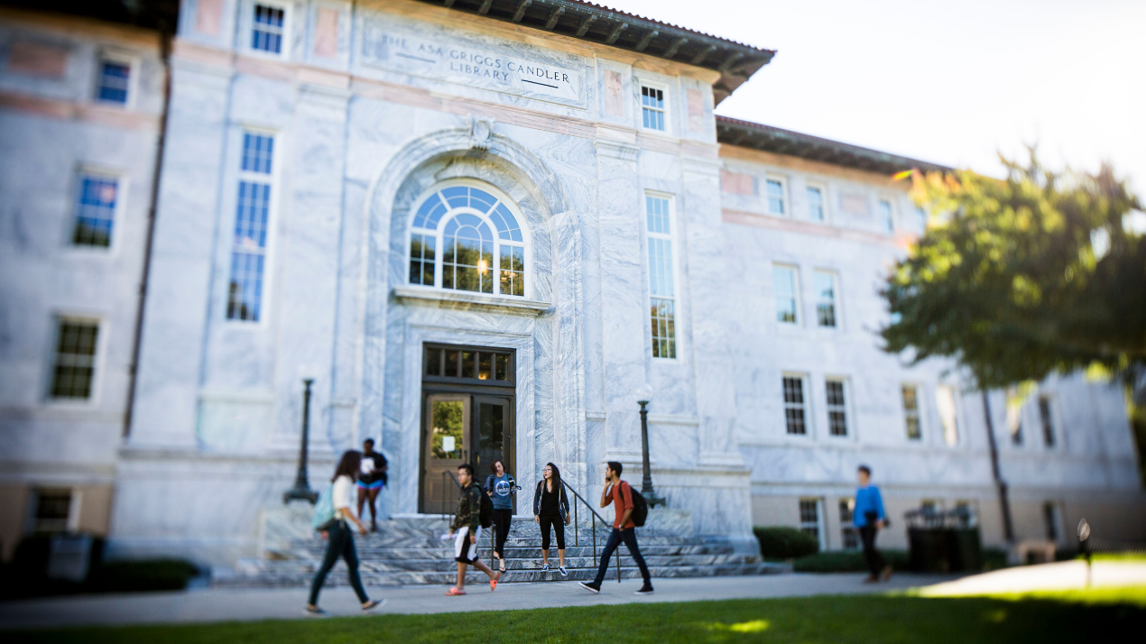 Students walking past Candler Library on the Emory campus quad
